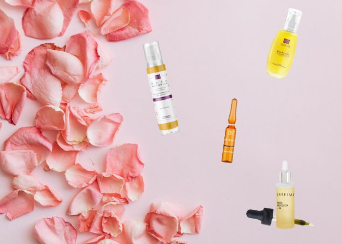 Productos cosm&eacute;ticos para pieles con ros&aacute;cea sobre p&eacute;talos de rosa